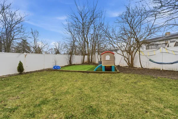 a view of a backyard with large trees