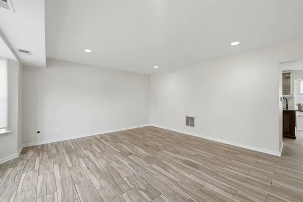 an empty room with wooden floor