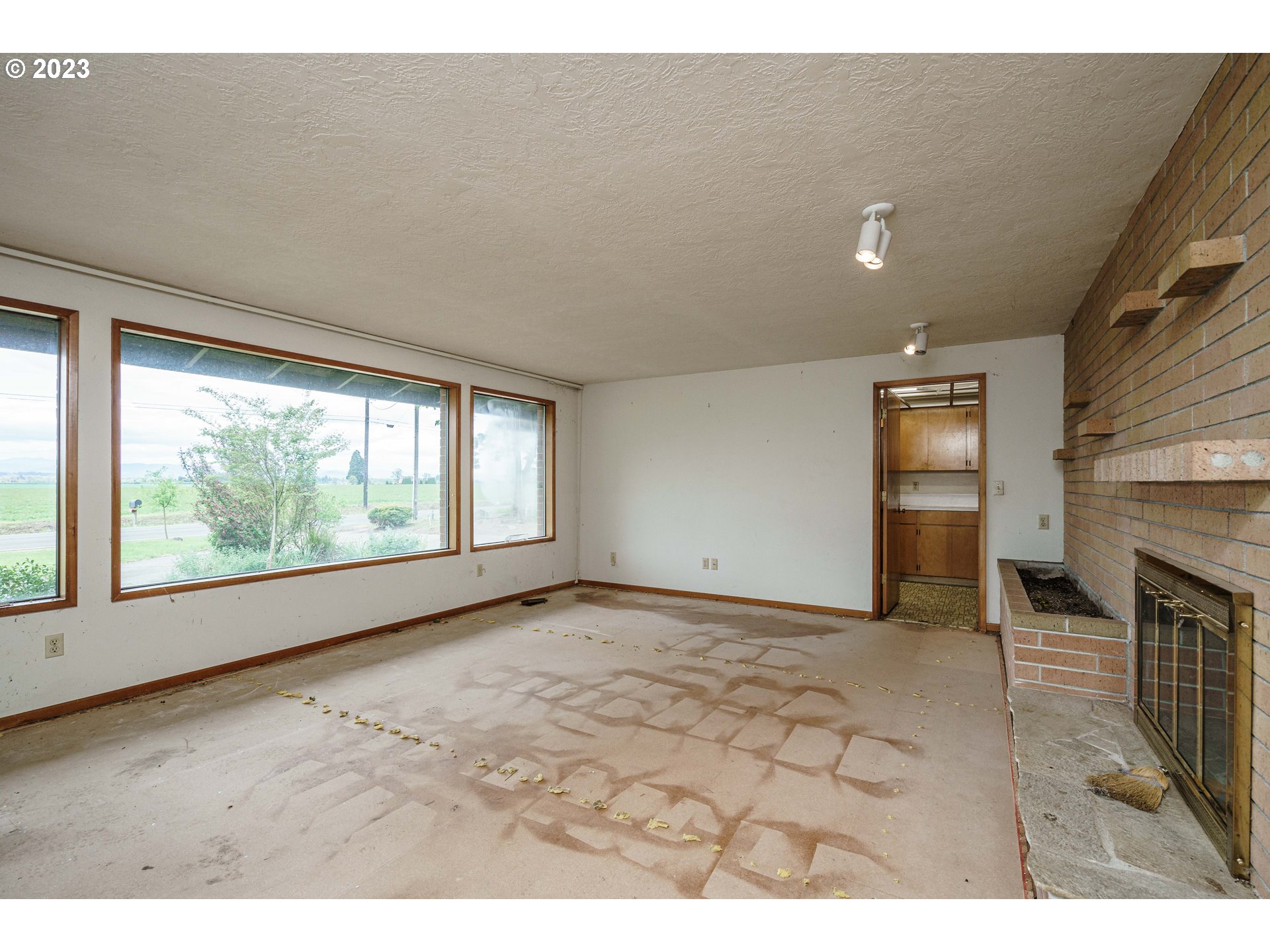 6300 Southwest Minter Bridge Road Hillsboro, OR 97123 - Photo 12 of 32 a view of an empty room with a fireplace and a window