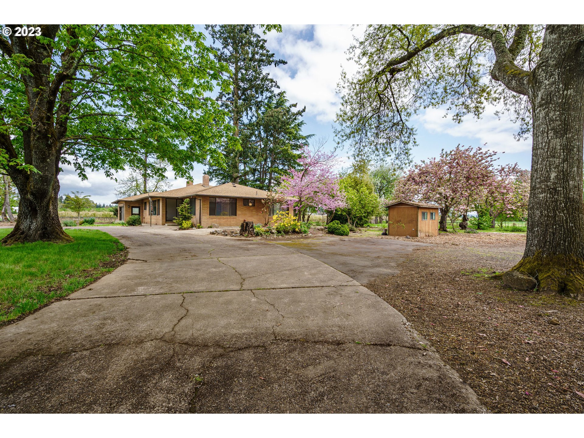 6300 Southwest Minter Bridge Road Hillsboro, OR 97123 - Photo 2 of 32 a front view of a house with a yard and trees