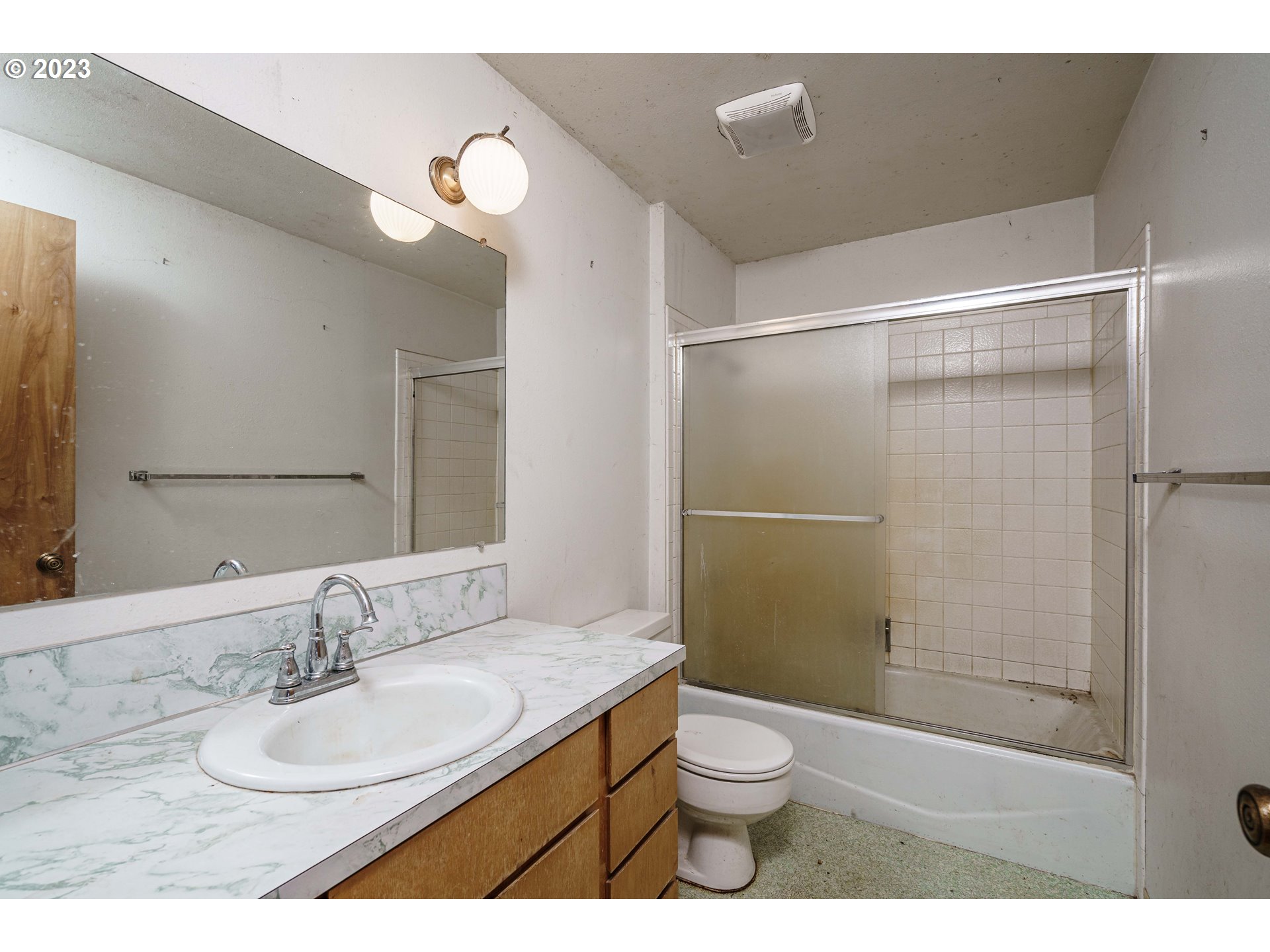 6300 Southwest Minter Bridge Road Hillsboro, OR 97123 - Photo 22 of 32 a bathroom with a granite countertop sink toilet a mirror and shower