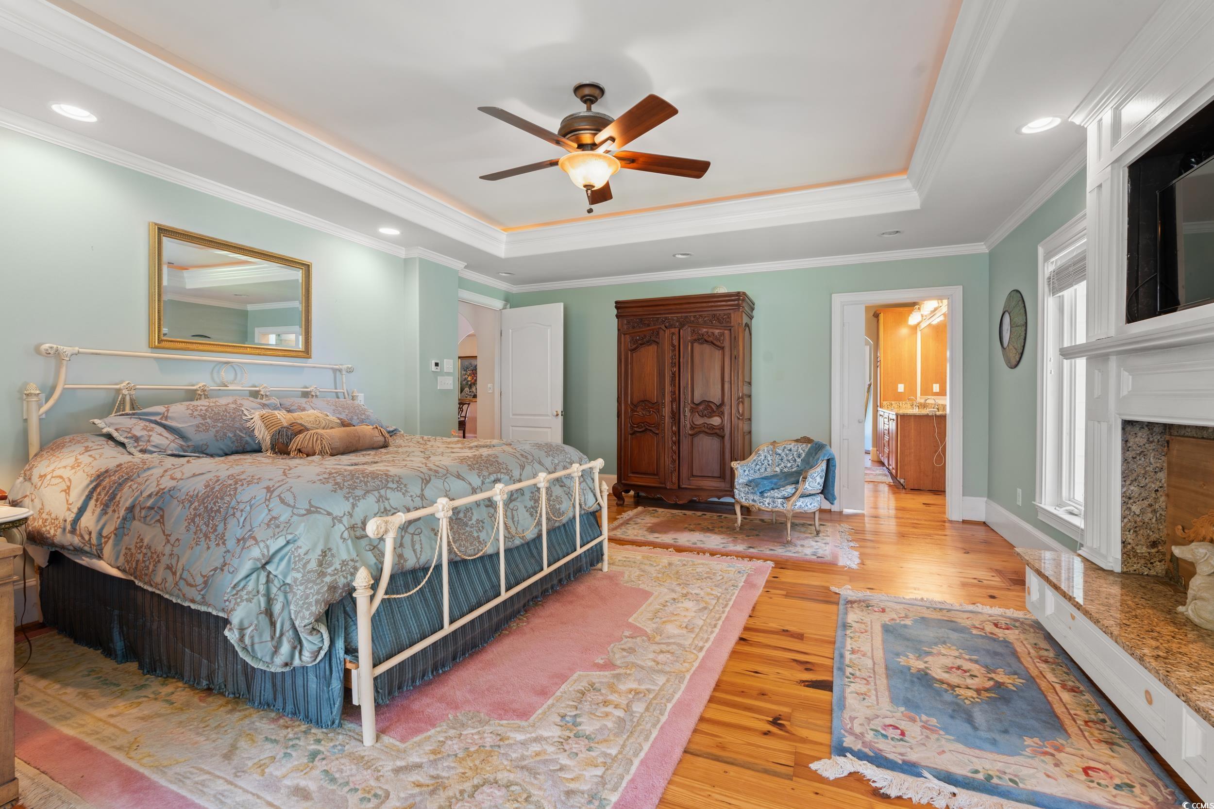 2790 Fowler Road Loris, SC 29569 - Photo 12 of 40 Bedroom featuring a raised ceiling, light wood finished floors, crown molding, a ceiling fan, and recessed lighting