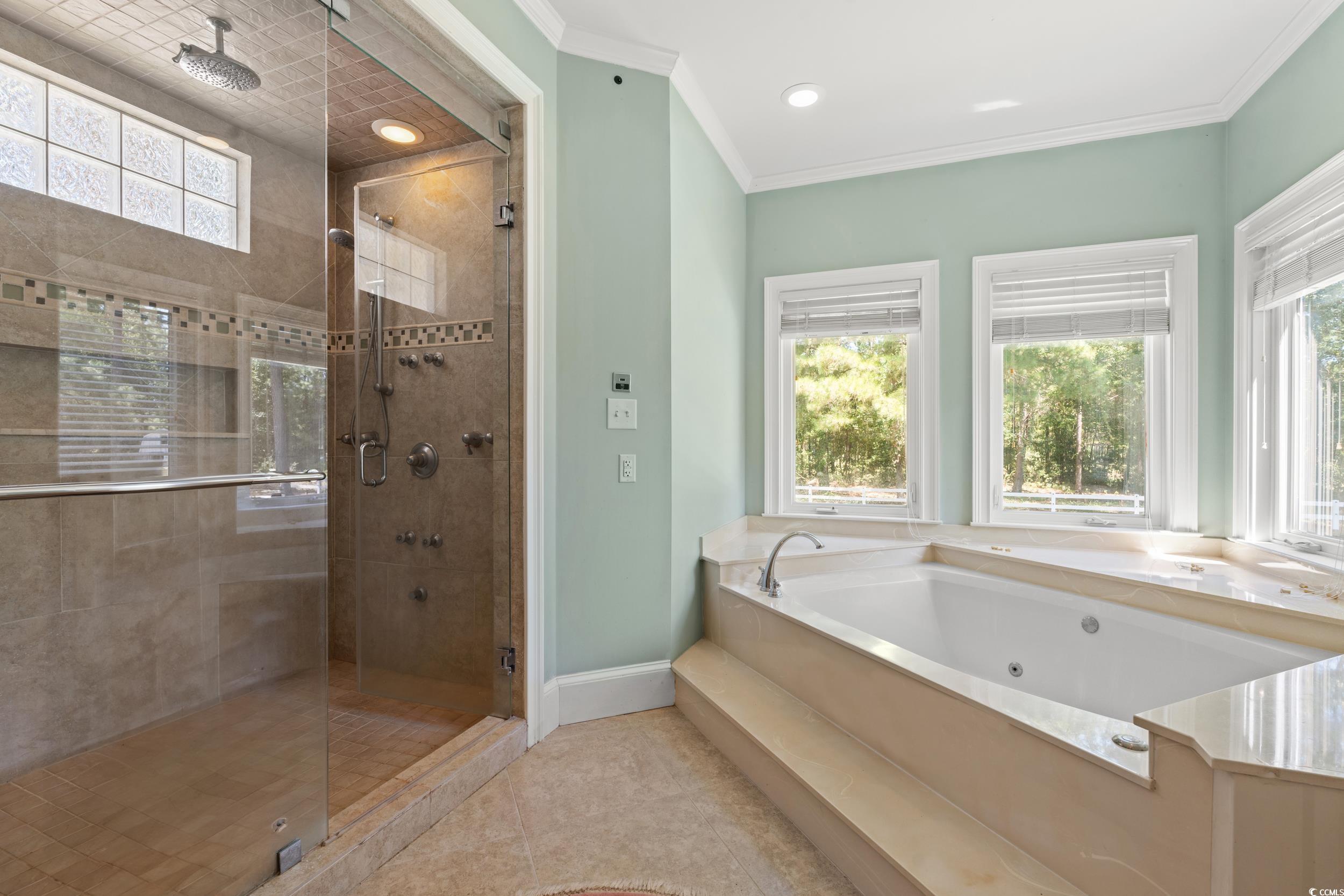 2790 Fowler Road Loris, SC 29569 - Photo 14 of 40 Full bathroom with a stall shower, crown molding, a tub with jets, light tile patterned flooring, and recessed lighting