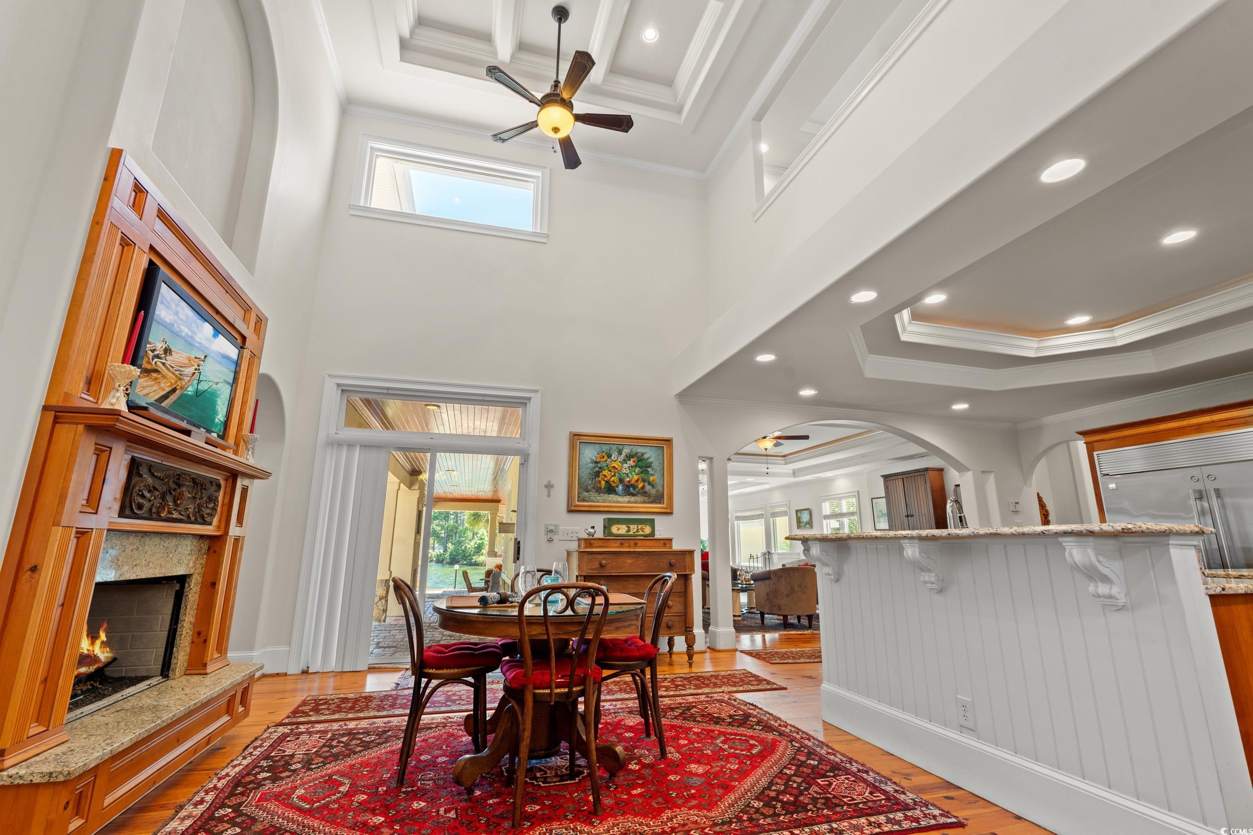 2790 Fowler Road Loris, SC 29569 - Photo 16 of 40 Dining space with ornamental molding, a raised ceiling, ceiling fan, recessed lighting, and light wood-style flooring