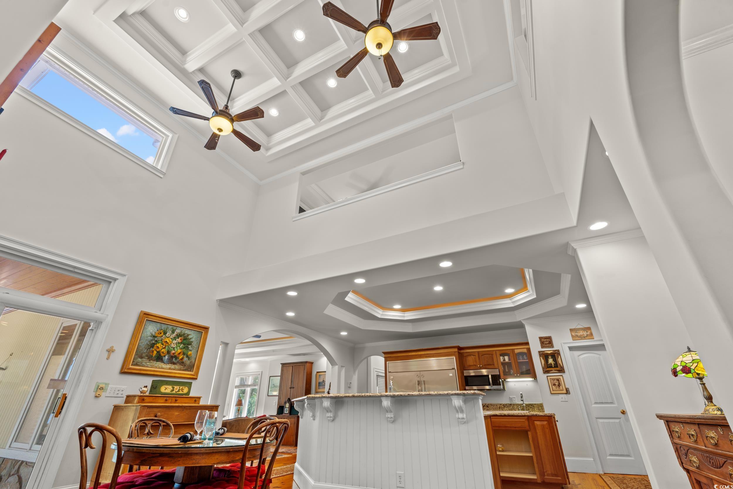 2790 Fowler Road Loris, SC 29569 - Photo 17 of 40 Kitchen featuring recessed lighting, a ceiling fan, coffered ceiling, light stone countertops, and a tray ceiling