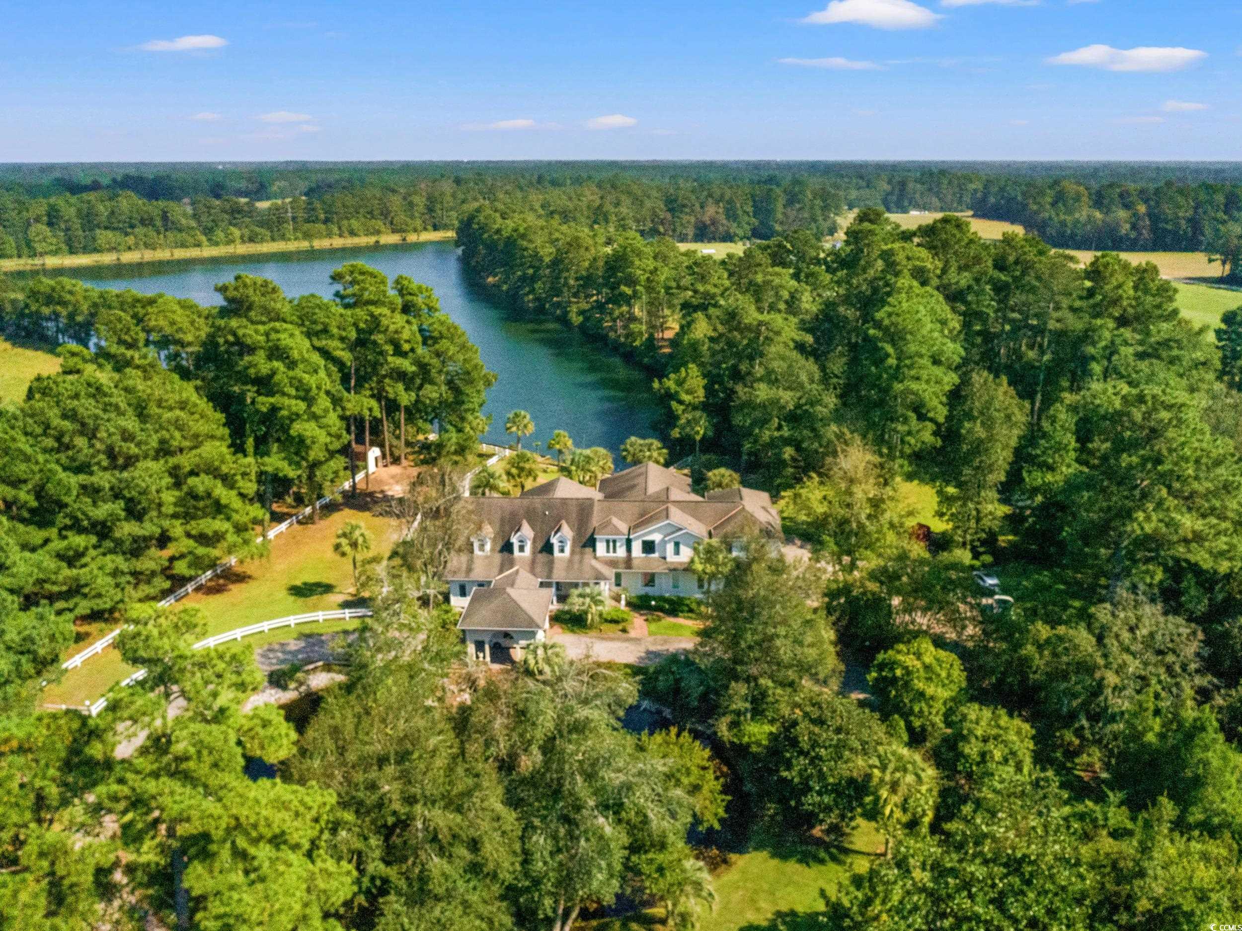 2790 Fowler Road Loris, SC 29569 - Photo 2 of 40 Aerial view of property's location with a heavily wooded area and a nearby body of water