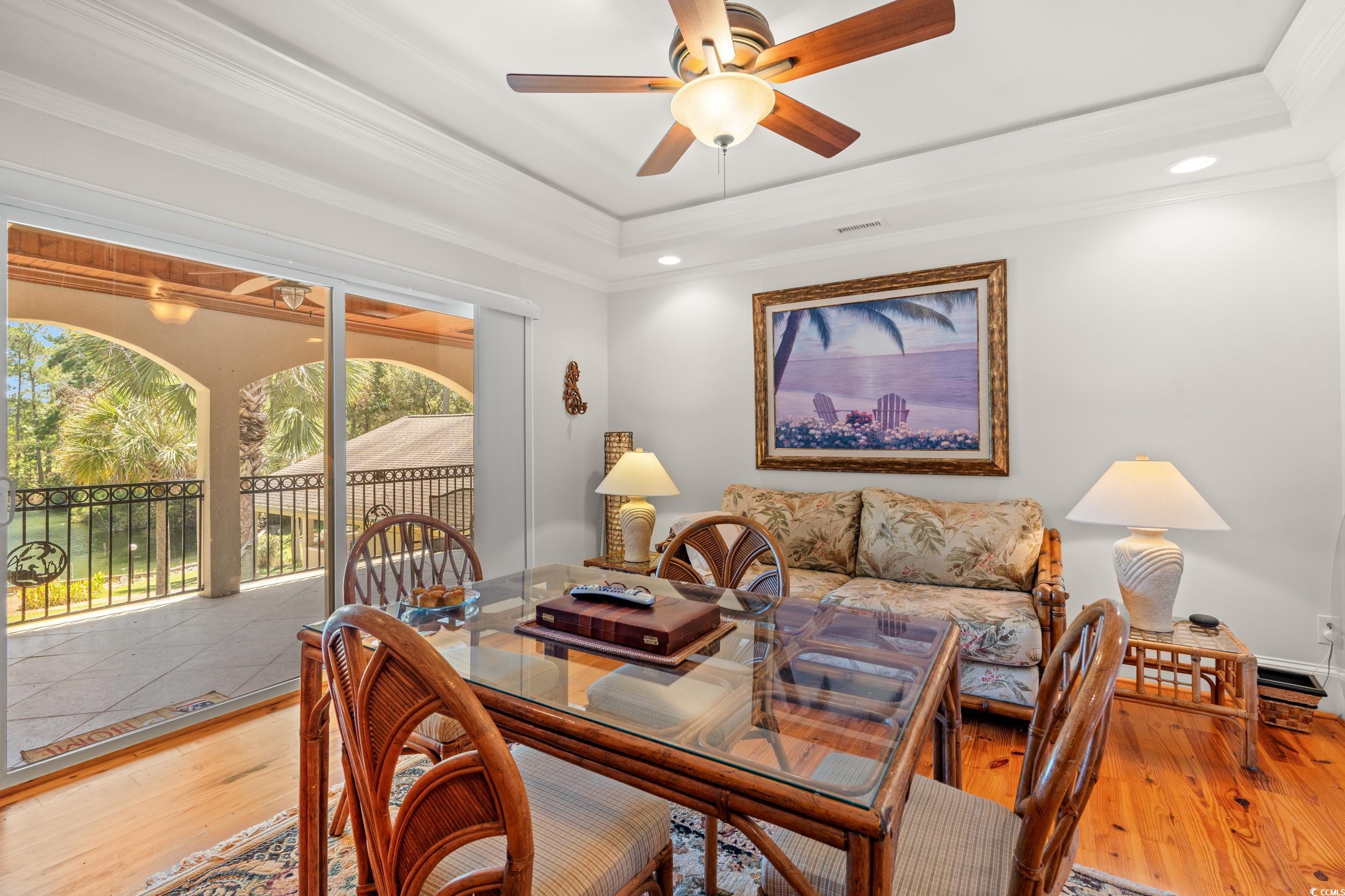 2790 Fowler Road Loris, SC 29569 - Photo 23 of 40 Dining space featuring wood finished floors, a raised ceiling, a ceiling fan, crown molding, and recessed lighting