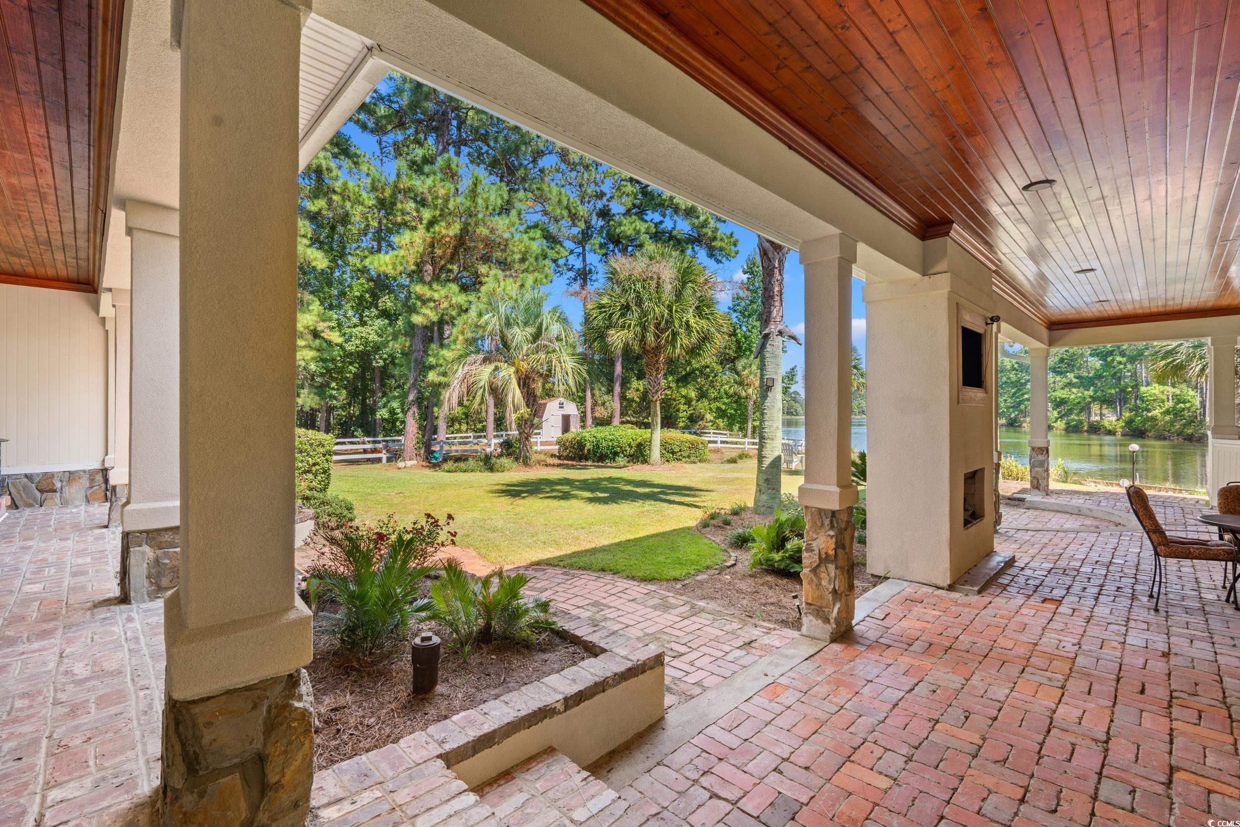 2790 Fowler Road Loris, SC 29569 - Photo 32 of 40 View of patio / terrace featuring a water view and view of scattered trees