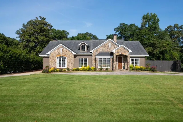 a front view of a house with a garden