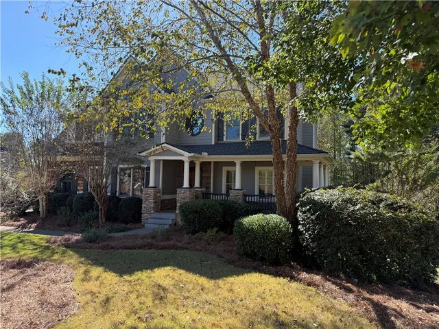a front view of a house with a garden