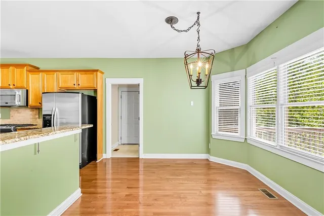 a view of a livingroom with wooden floor and a sink