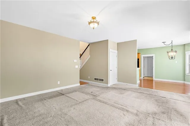 an empty room with fan and a ceiling fan