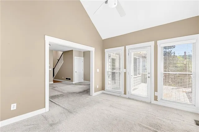 an empty room with closet and a chandelier fan