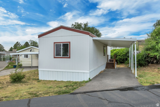 142 Cushing Way Layton, UT 84041 - Photo 15 of 15 White siding exterior with a red trim roofline