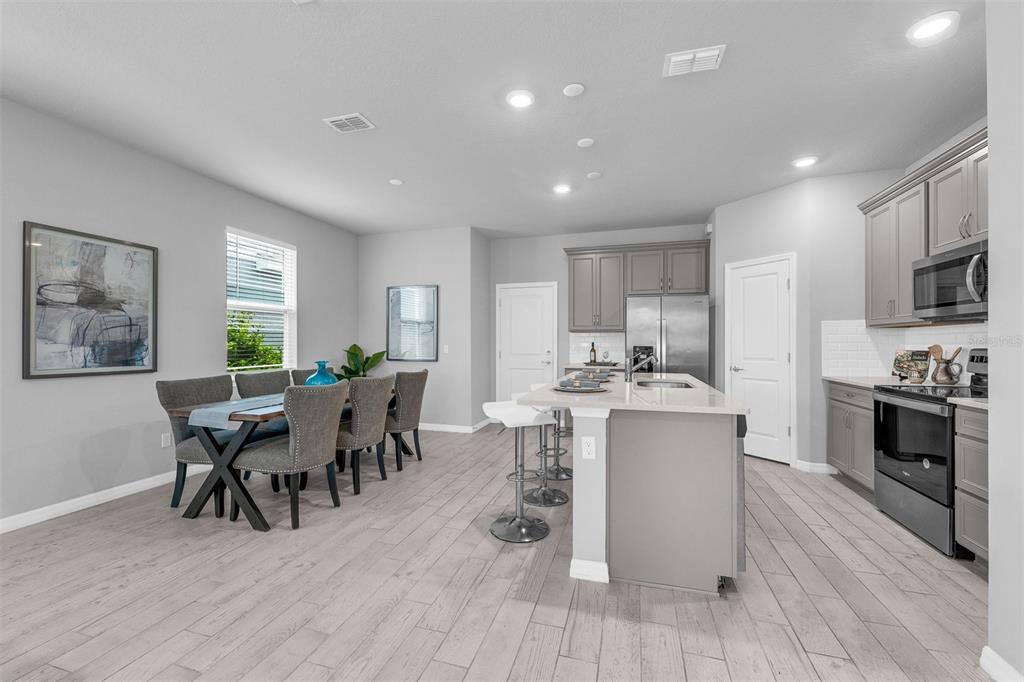 2765 Franklin Road St. Cloud, FL 34771 - Photo 3 of 29 a view of a dining room with furniture window and wooden floor