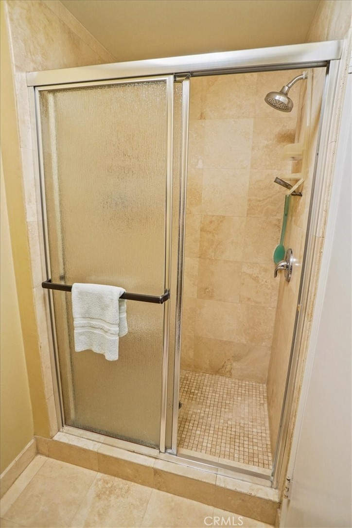 19334 Oak Crossing Road Newhall, CA 91321 - Photo 12 of 36 a bathroom with a glass shower door