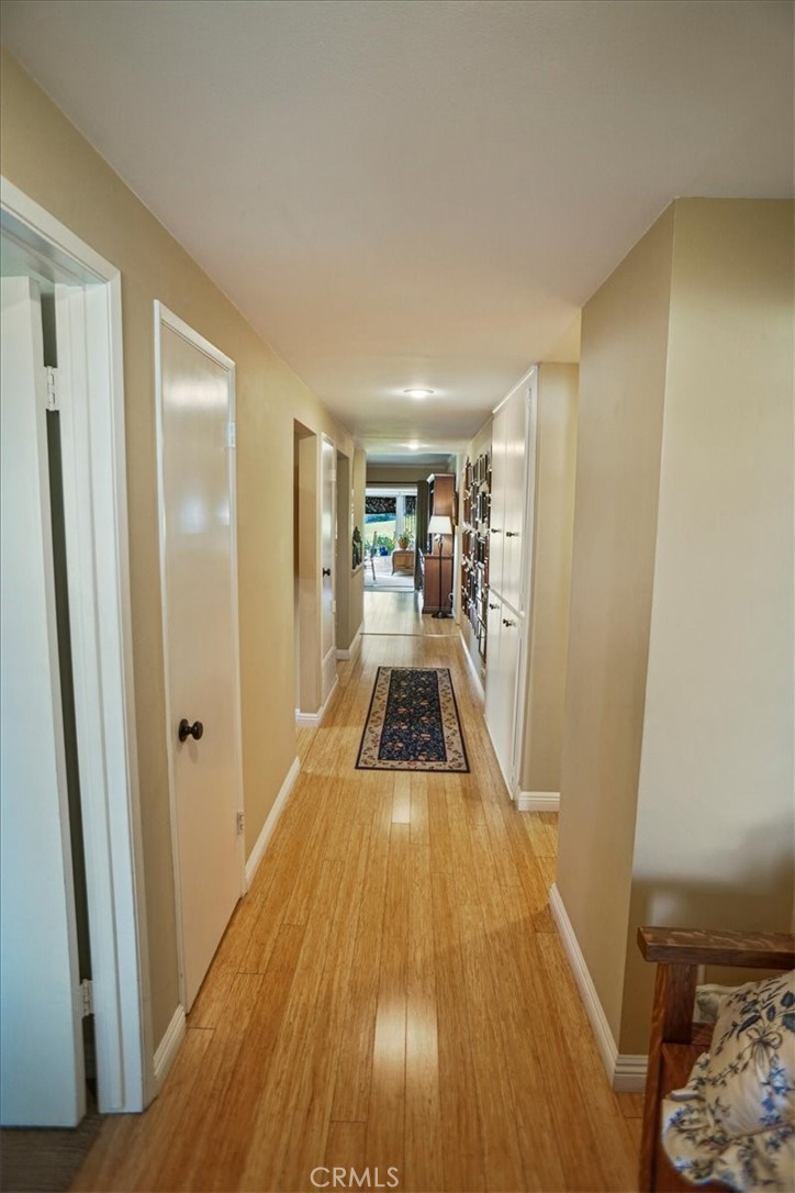 19334 Oak Crossing Road Newhall, CA 91321 - Photo 2 of 36 a view of a hallway with wooden floor