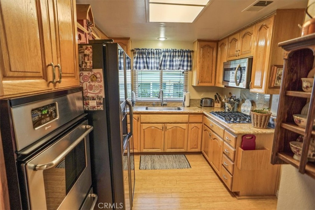 19334 Oak Crossing Road Newhall, CA 91321 - Photo 6 of 36 a kitchen with a sink stove and cabinets