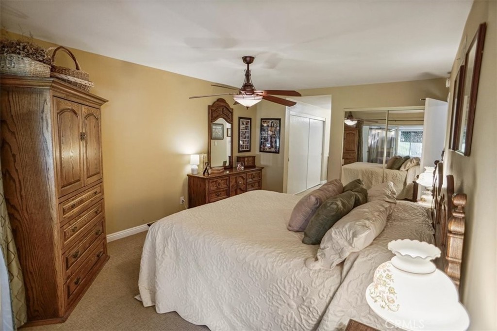 19334 Oak Crossing Road Newhall, CA 91321 - Photo 10 of 36 a bedroom with bed and a chandelier