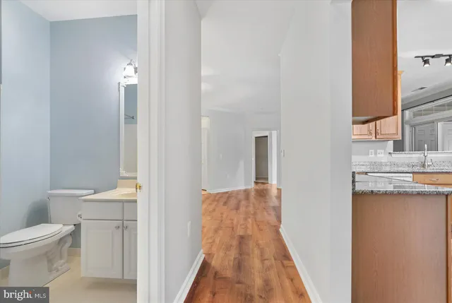 a bathroom with a toilet a sink and a mirror