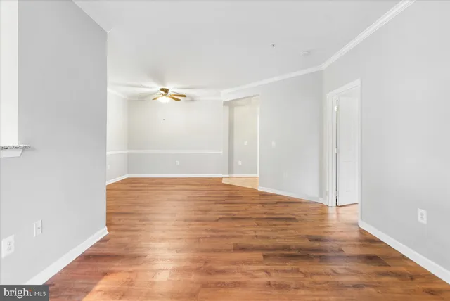 a view of a room with wooden floor