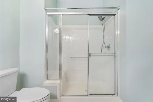 a bathroom with a toilet and a shower