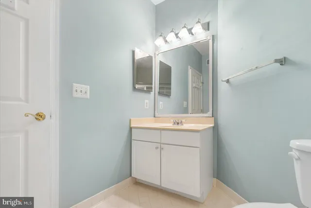 a bathroom with a sink vanity and mirror