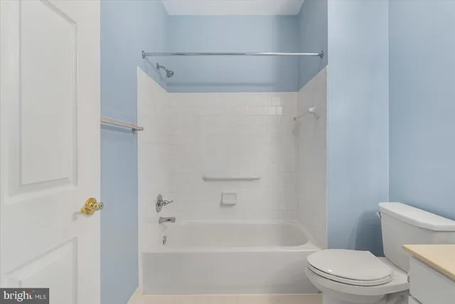 a bathroom with a toilet and a bath tub