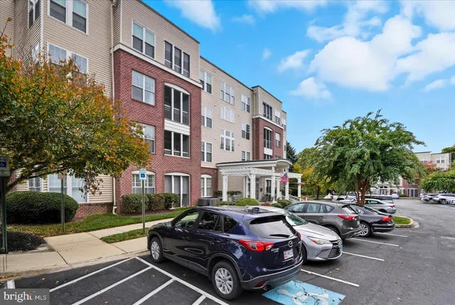 a view of a cars park in front of a building