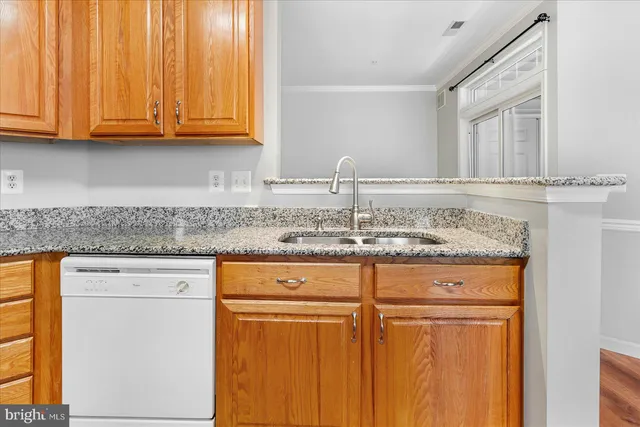 a kitchen with granite countertop cabinets and a sink