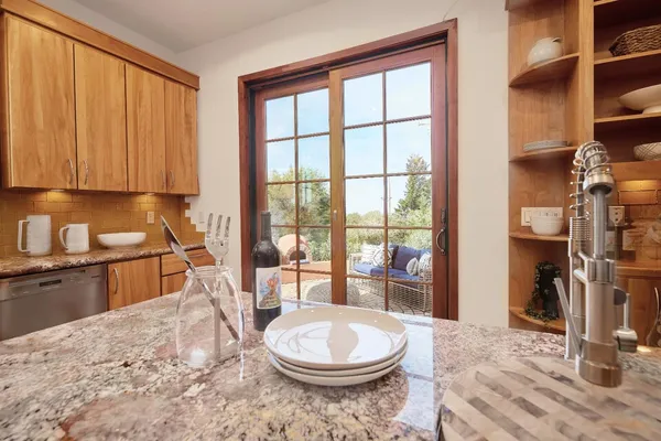 a bathroom with a granite countertop sink a toilet a mirror and shower