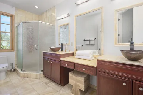 a bathroom with a sink a toilet and shower