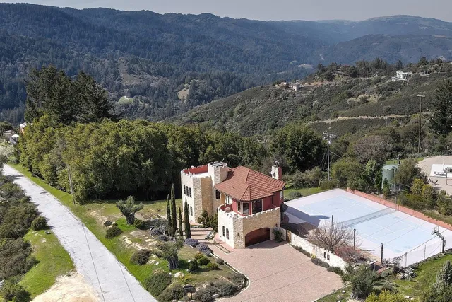 an aerial view of a house with mountain view