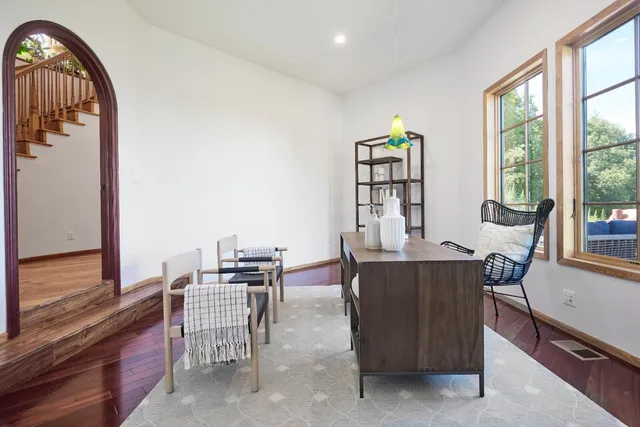 a view of a dining room with furniture and a window