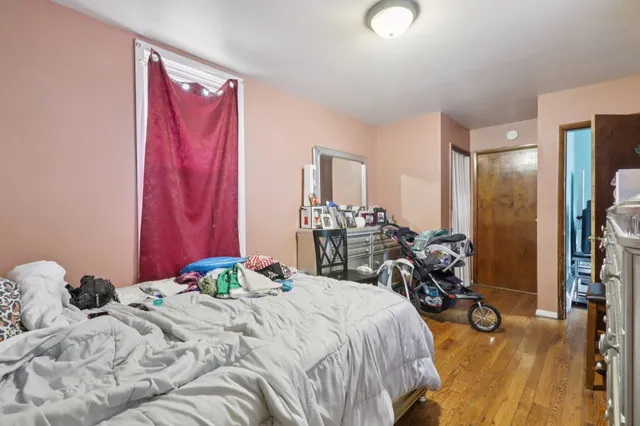 a bedroom with bed and a mirror