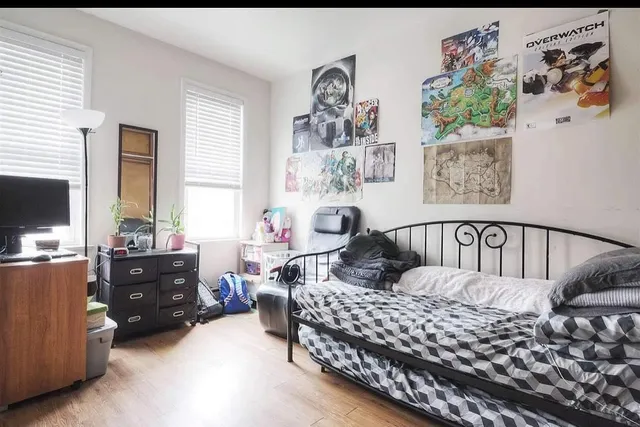 a bedroom with furniture and a window