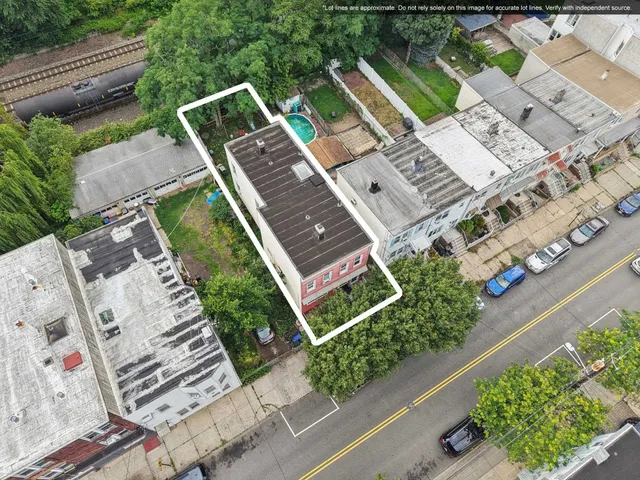 an aerial view of a house with garden space and street view