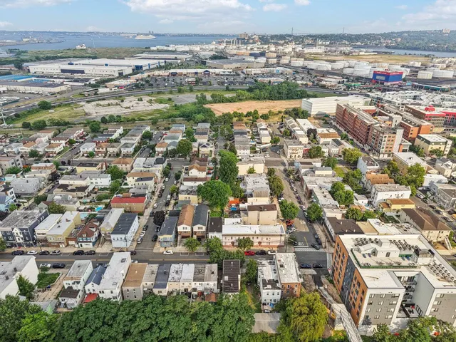 an aerial view of residential houses with city view