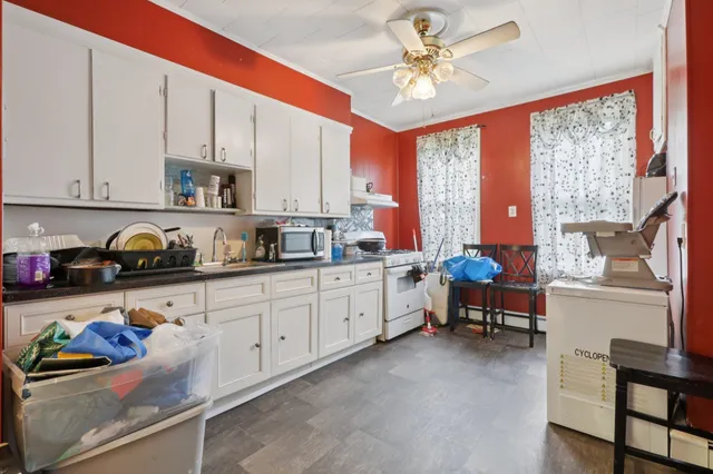 a kitchen with stainless steel appliances sink cabinets and window