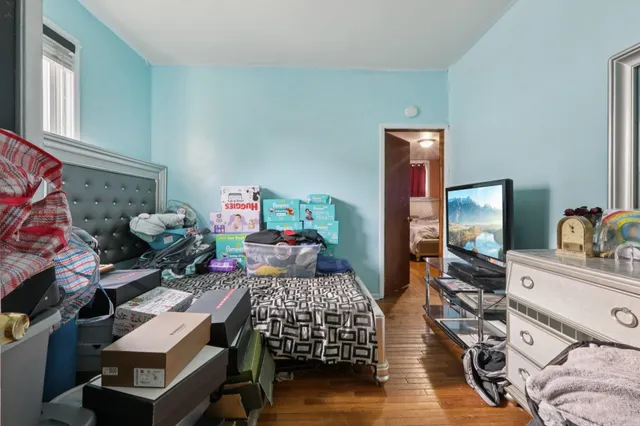 a bedroom with two beds and a dresser