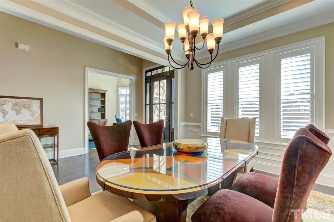 8205 Cranes View Place East Raleigh, NC 27615 - Photo 11 of 30 a outdoor dining room with furniture a chandelier and wooden floor