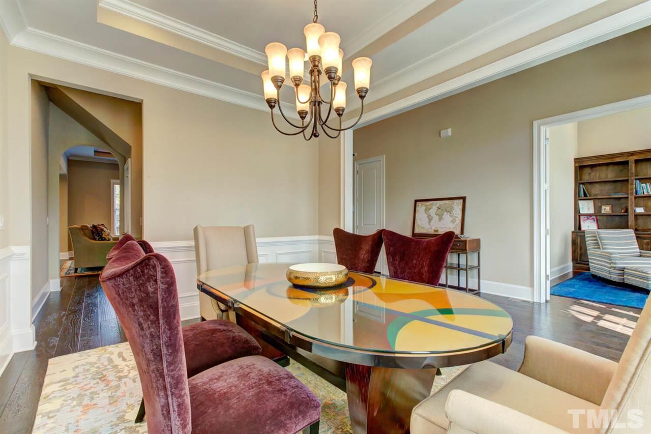 8205 Cranes View Place East Raleigh, NC 27615 - Photo 12 of 30 a view of a dining room with furniture and wooden floor