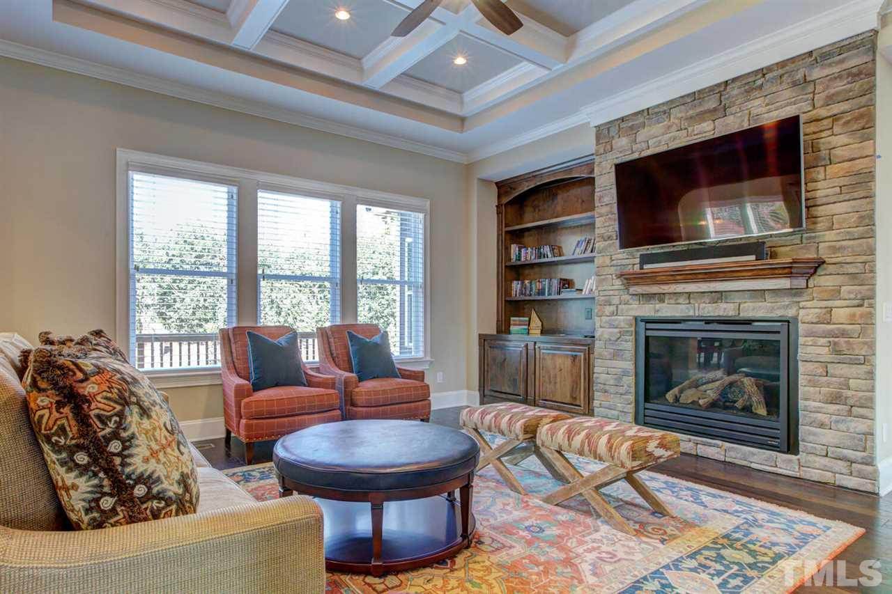 8205 Cranes View Place East Raleigh, NC 27615 - Photo 15 of 30 a living room with furniture a flat screen tv and a fireplace