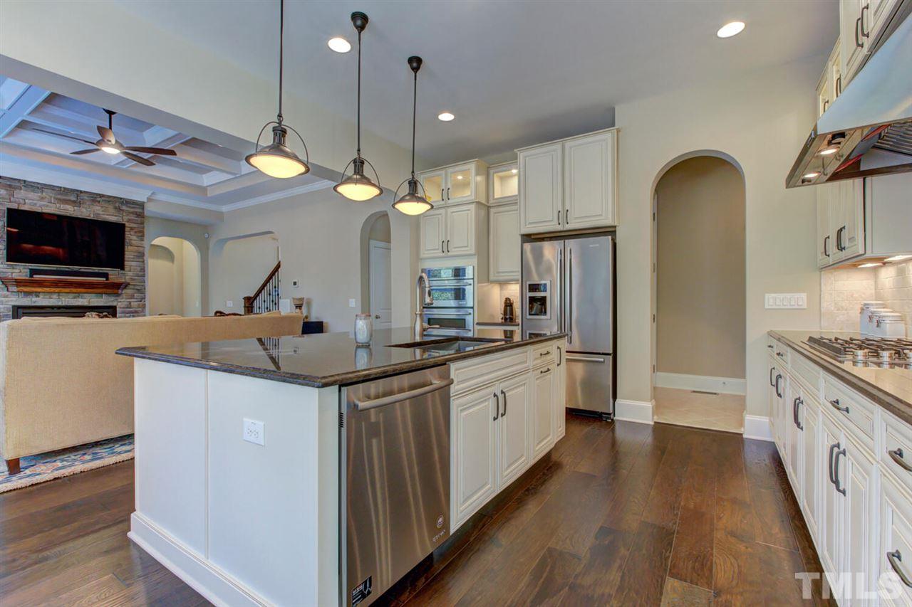 8205 Cranes View Place East Raleigh, NC 27615 - Photo 22 of 30 a kitchen with granite countertop a stove and a sink