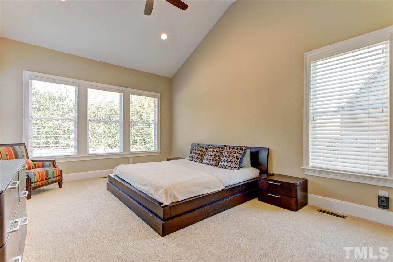 8205 Cranes View Place East Raleigh, NC 27615 - Photo 23 of 30 a bed sitting in a spacious bedroom next to a window