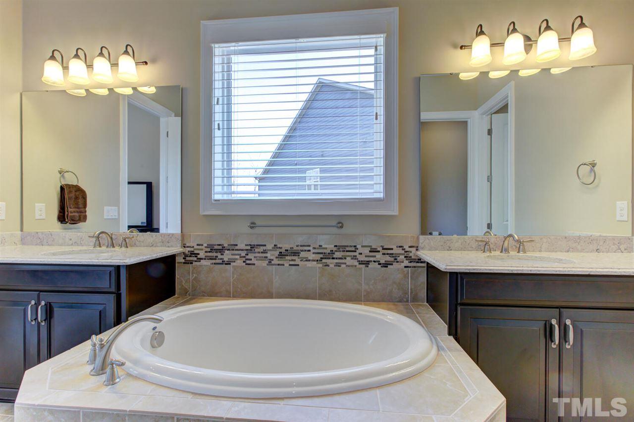 8205 Cranes View Place East Raleigh, NC 27615 - Photo 24 of 30 a bathroom with a tub sink and mirror