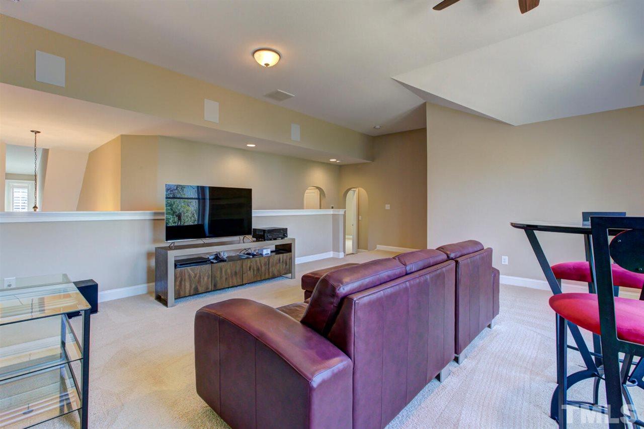 8205 Cranes View Place East Raleigh, NC 27615 - Photo 27 of 30 a living room with furniture and a flat screen tv