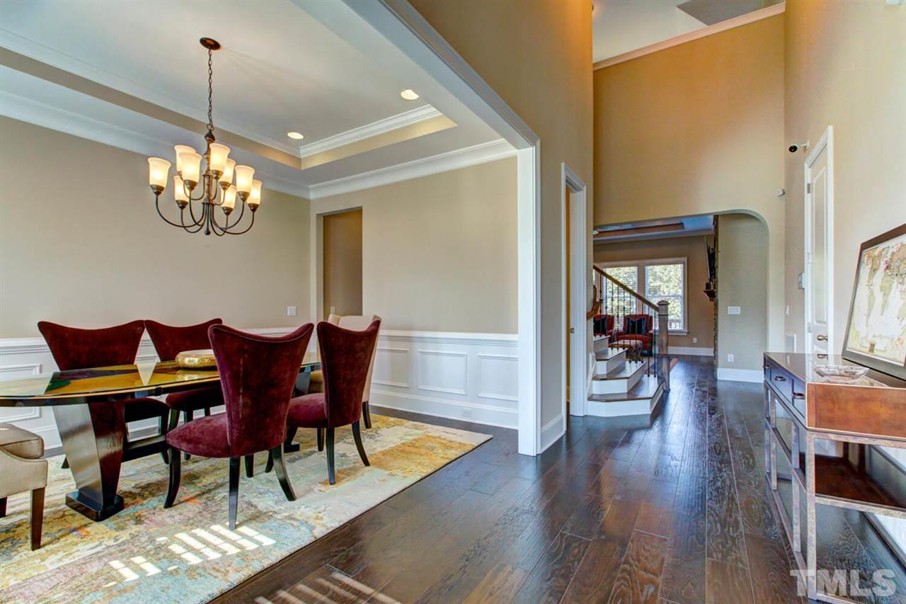 8205 Cranes View Place East Raleigh, NC 27615 - Photo 8 of 30 a view of a dining room with furniture and wooden floor