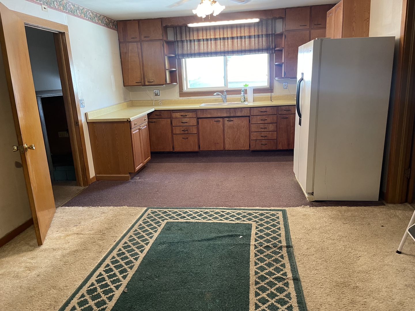 202 South Pleasant Street Rutland, IL 61358 - Photo 5 of 13 a kitchen with refrigerator and window