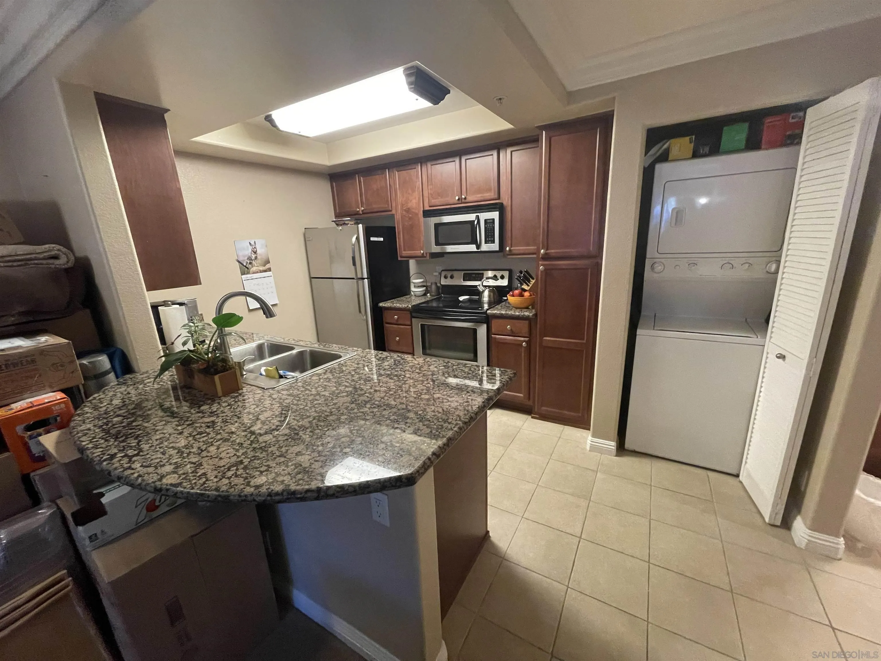 1434 Marshall Road, Unit 56 Alpine, CA 91901 - Photo 6 of 15 a kitchen with kitchen island granite countertop a sink stove and refrigerator